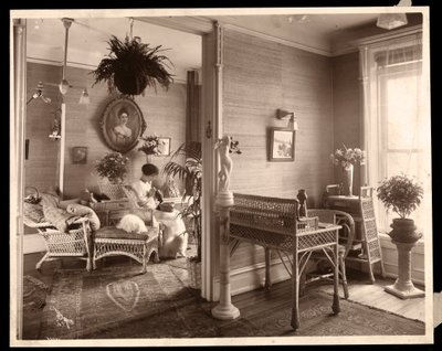 A woman doing needlework in a sitting room, 1914 or 1915 by Byron Company